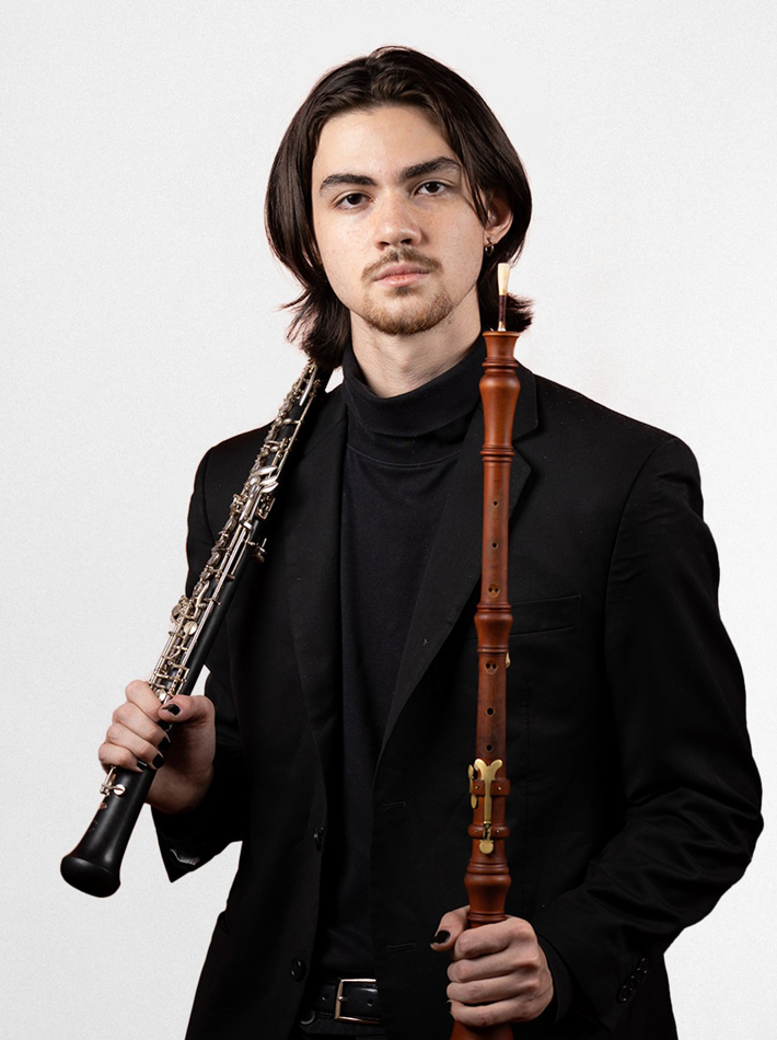 Pablo O'Connell holding two oboes