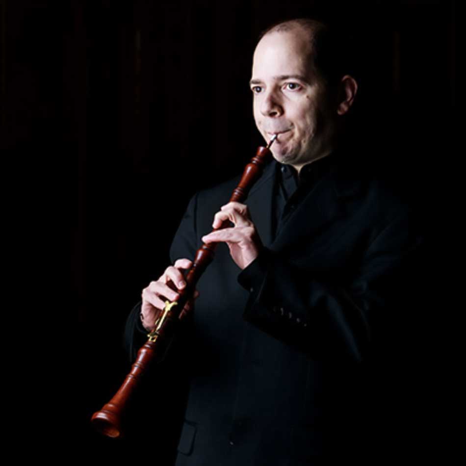 Stephen Bard Headshot playing the oboe